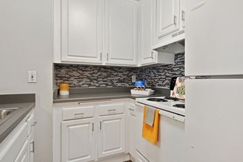 Kitchen With White Cabinetry And Appliances at Twenty 2 Eleven Apartments, Canoga Park, CA